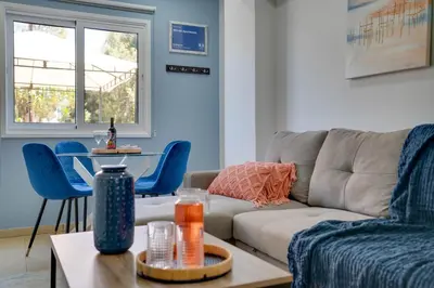 a living room with a couch and a table at Atlantis Apartments 50m from Makenzy seafront in Larnaka