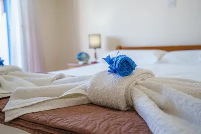 a bedroom with a bed with towels on it at The Valley Beyond in Paralimni