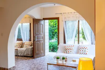 a living room with a white couch and a window at Buena Vista Villa in Protaras
