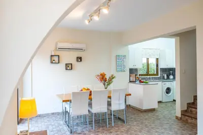 a kitchen and dining room with a table and chairs at Buena Vista Villa in Protaras