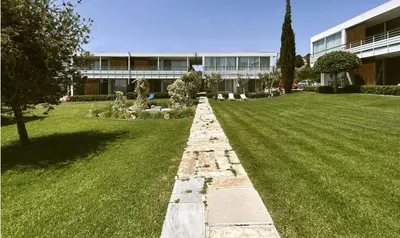 a long stone pathway in front of a building at Art by PraXis in Governors Beach