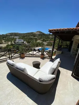 a couch sitting on top of a patio at Lefkara Villa in Kato Lefkara