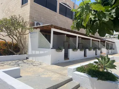 a building with stairs and plants in front of it at Blue Peter Apartments in Protaras