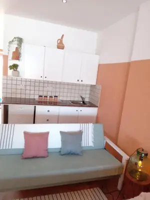 a room with a bench with two pillows on it at Blue Peter Apartments in Protaras