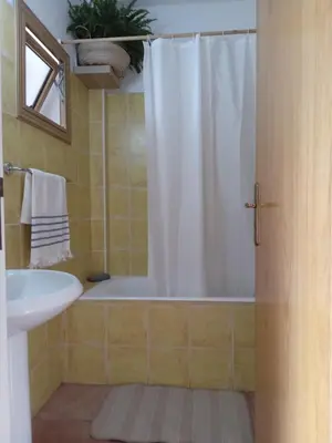 a bathroom with a tub and a sink and a shower at Blue Peter Apartments in Protaras