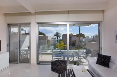 a living room with a couch and a balcony at Opera Exclusive Apts by TrulyCyprus in Limassol