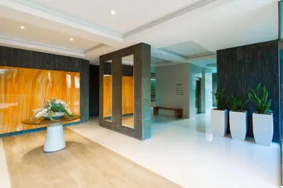 a lobby with a table and some plants at Opera Exclusive Apts by TrulyCyprus in Limassol