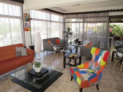 a living room with a couch and chairs at Carina Hotel Apartments in Ayia Napa