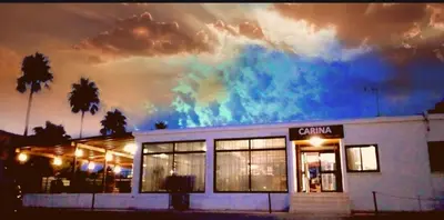 a building with a colorful sky in the background at Carina Hotel Apartments in Ayia Napa