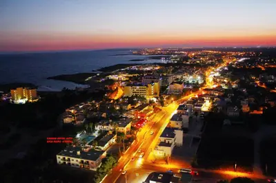 an aerial view of a city at night at Carina Hotel Apartments in Ayia Napa