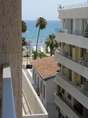 a view of the beach from the balcony of a building at Camilla City apartment in Larnaka