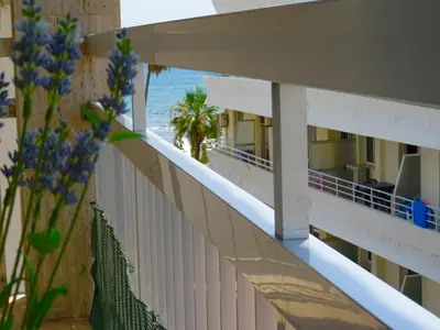 a balcony of a hotel with a view of the beach at Camilla City apartment in Larnaka