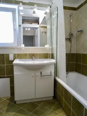 a bathroom with a sink and a shower and a mirror at Camilla City apartment in Larnaka