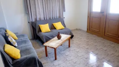 a living room with a couch and a coffee table at House on the hill in Xylophaghou