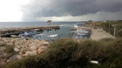 a group of boats docked at a dock in the water at House on the hill in Xylophaghou