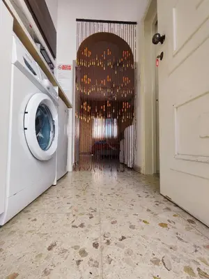 a hallway with a washing machine in a room at Elena Holiday Apartment in Larnaka