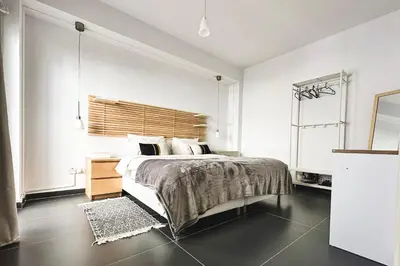 a bedroom with a large bed with a wooden headboard at Home Away One Bedroom Apartment in Nicosia in Nicosia