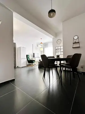 a living room with a table and chairs in it at Home Away One Bedroom Apartment in Nicosia in Nicosia