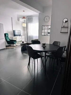 a dining room with a table and chairs in a room at Home Away One Bedroom Apartment in Nicosia in Nicosia
