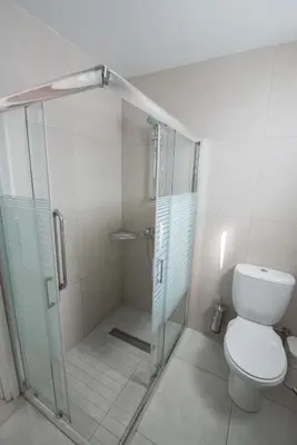 a bathroom with a shower and a toilet at La Casa Di Napa Apartments in Ayia Napa