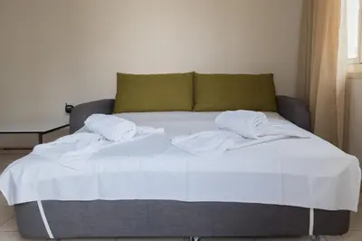 a bed with towels on it in a room at La Casa Di Napa Apartments in Ayia Napa