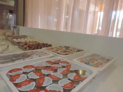 a buffet of different types of food in trays at La Casa Di Napa Apartments in Ayia Napa