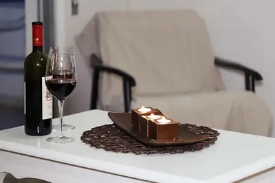 a bottle of wine and a glass on a table at Maria Court 2, Apt 32 in Larnaka