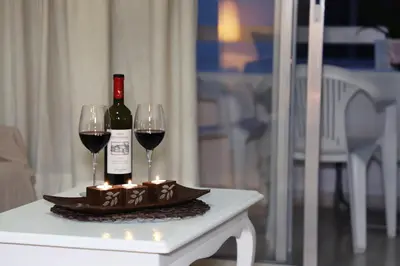 a bottle of wine and two glasses on a table at Maria Court 2, Apt 32 in Larnaka