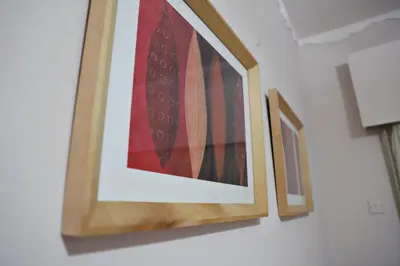 three framed pictures of ties hanging on a wall at Maria Court 2, Apt 32 in Larnaka