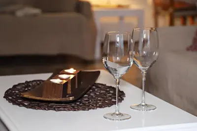 a table with two wine glasses and a plate of food at Maria Court 2, Apt 32 in Larnaka