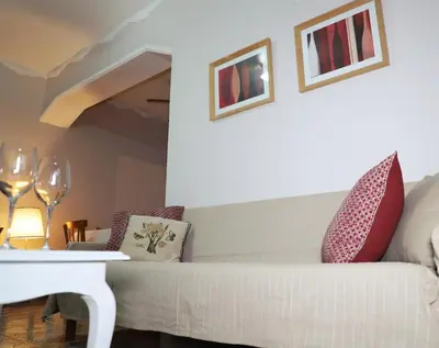 a living room with a white couch and a table at Maria Court 2, Apt 32 in Larnaka
