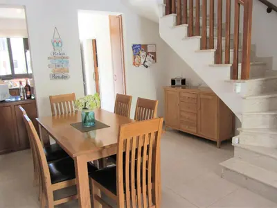 a dining room with a wooden table and chairs at Villa Jade in Paralimni