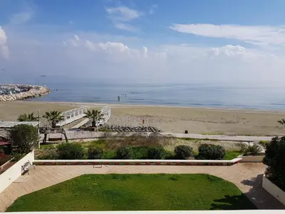 a view of a beach and the ocean from a building at Haig's Dream Flat On The Beach in Larnaka