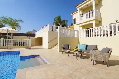 a villa with a swimming pool and a house at Villa Cleopatra in Ayia Napa