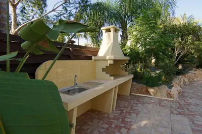 a outdoor kitchen with a sink in a garden at Villa Cleopatra in Ayia Napa