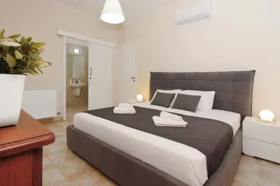 a bedroom with a large bed with two towels on it at Villa Cleopatra in Ayia Napa