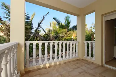 a balcony with a view of palm trees at Villa Cleopatra in Ayia Napa