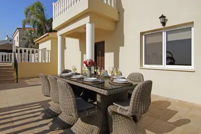 a dining room table and chairs in a house at Villa Cleopatra in Ayia Napa