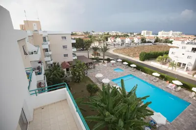 a view of the pool from the balcony of a building at DebbieXenia Hotel Apartments in Protaras