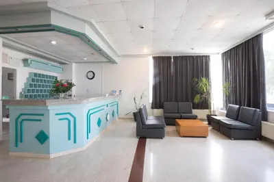 a hospital waiting room with two chairs and a counter at DebbieXenia Hotel Apartments in Protaras