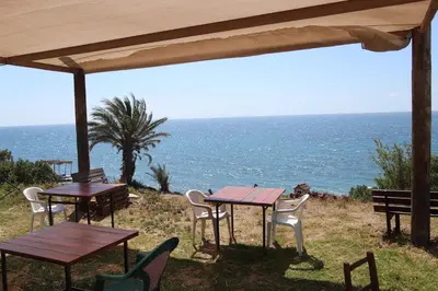 two tables and chairs with the ocean in the background at Summer Dream Cyprus in Maroni