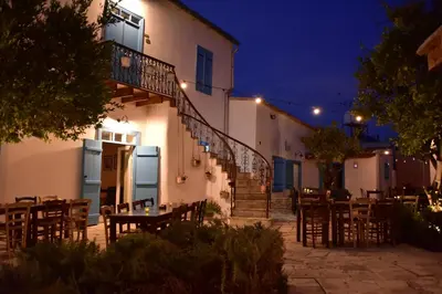 a restaurant with tables and chairs in front of a building at Athieno - Αθηαινώ in Athienou