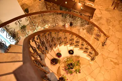 an overhead view of a spiral staircase with plants at Athieno - Αθηαινώ in Athienou