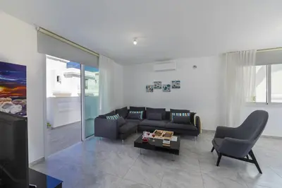 a living room with a couch and a table at Protaras Villa Araella in Ayia Napa