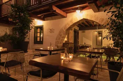 a restaurant with tables and chairs in a room at Oinou Strata - Adults Only in Vouni