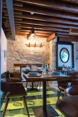 a dining room with a wooden table and chairs at Oinou Strata - Adults Only in Vouni