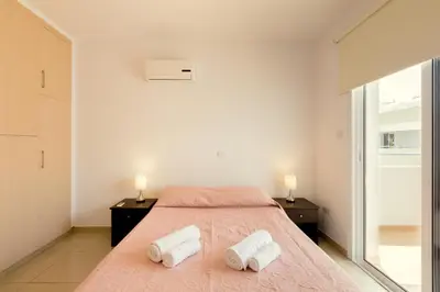 a bedroom with a bed with two towels on it at Oceania Bay Village in Pyla
