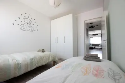 a bedroom with two beds and a mirror at Glabur Stays - The Cozy 2 BDR - Nicosia City, Free Parking & Wifi, Welcomes You!!! in Nicosia