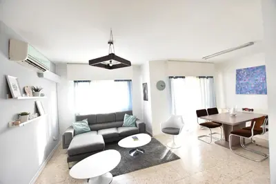 a living room with a couch and a table at Glabur Stays - The Cozy 2 BDR - Nicosia City, Free Parking & Wifi, Welcomes You!!! in Nicosia