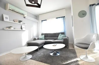 a living room with a couch and a table and chairs at Glabur Stays - The Cozy 2 BDR - Nicosia City, Free Parking & Wifi, Welcomes You!!! in Nicosia